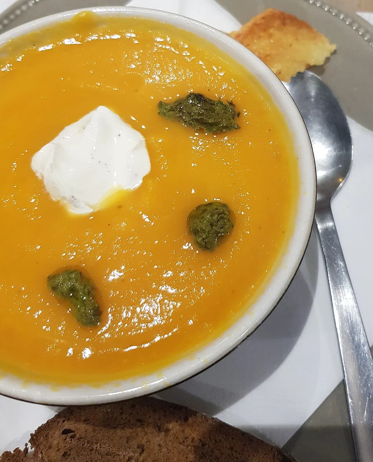 Foto da receita: Creme de Abóbora com Gengibre - Sopa cremosa de abóbora cabotiá assada com cebola, alho e gengibre, batida até ficar aveludada. Leve, nutritiva e com sementes torradas por cima.